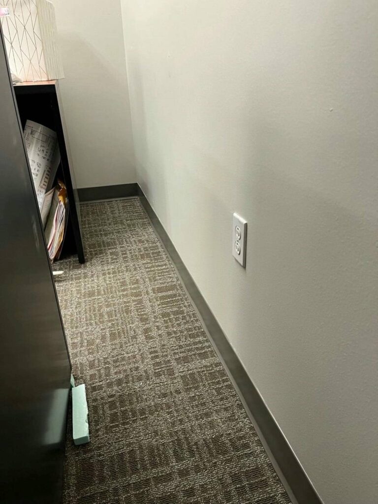 Corner of an office with floor damage