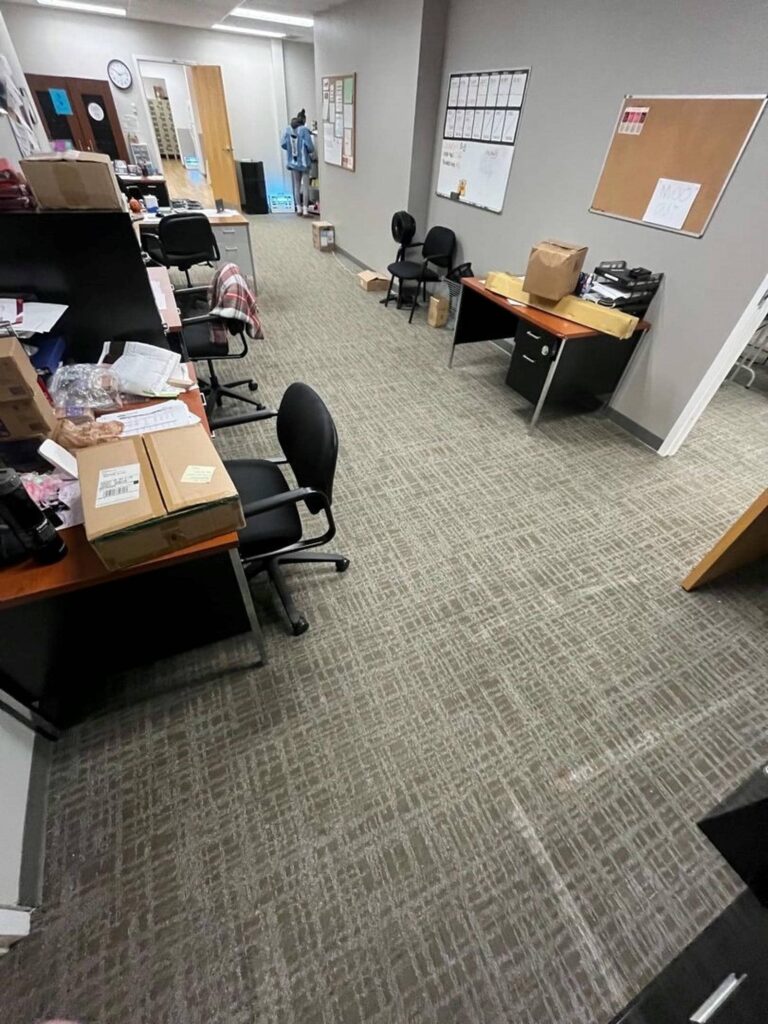 Cluttered office space with empty chairs