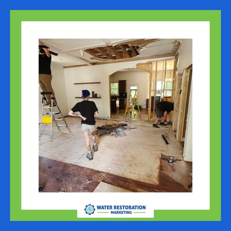 Workers repairing water-damaged interior space.