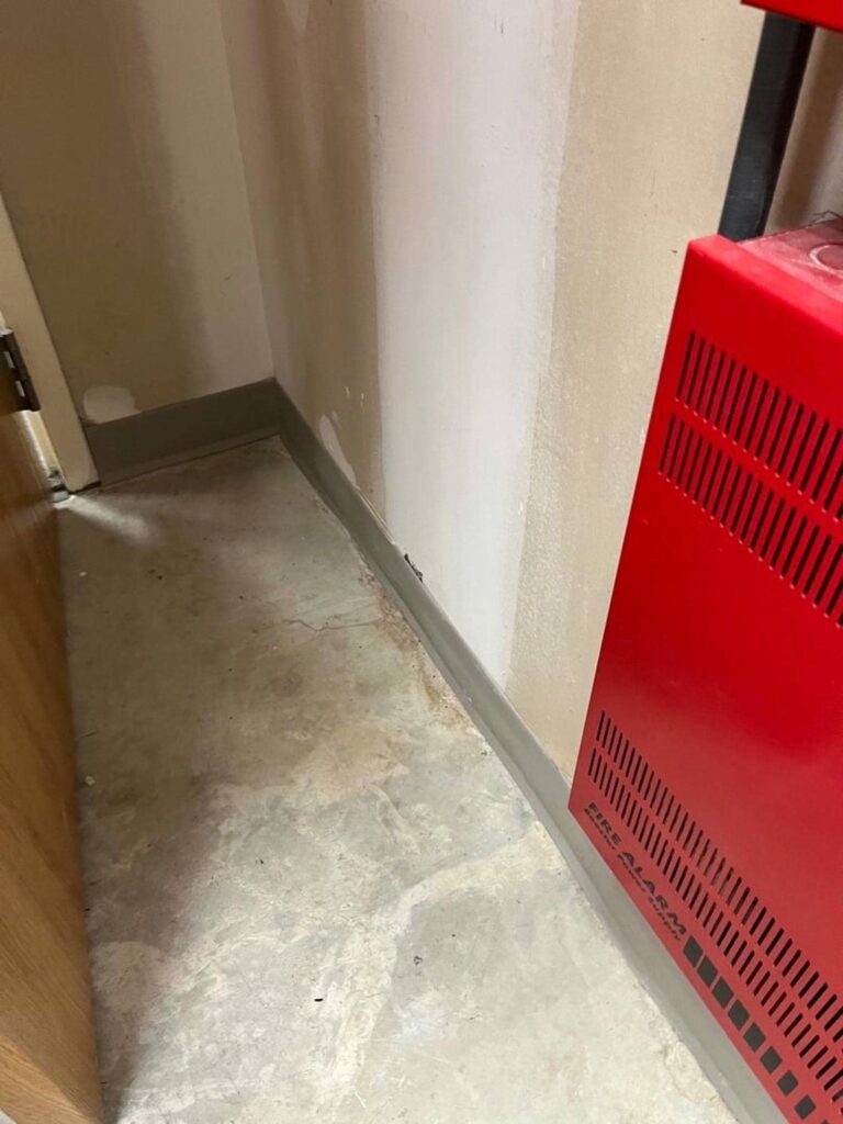Corner of a room with floor damage