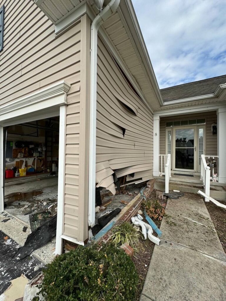Severely damaged house exterior and garage