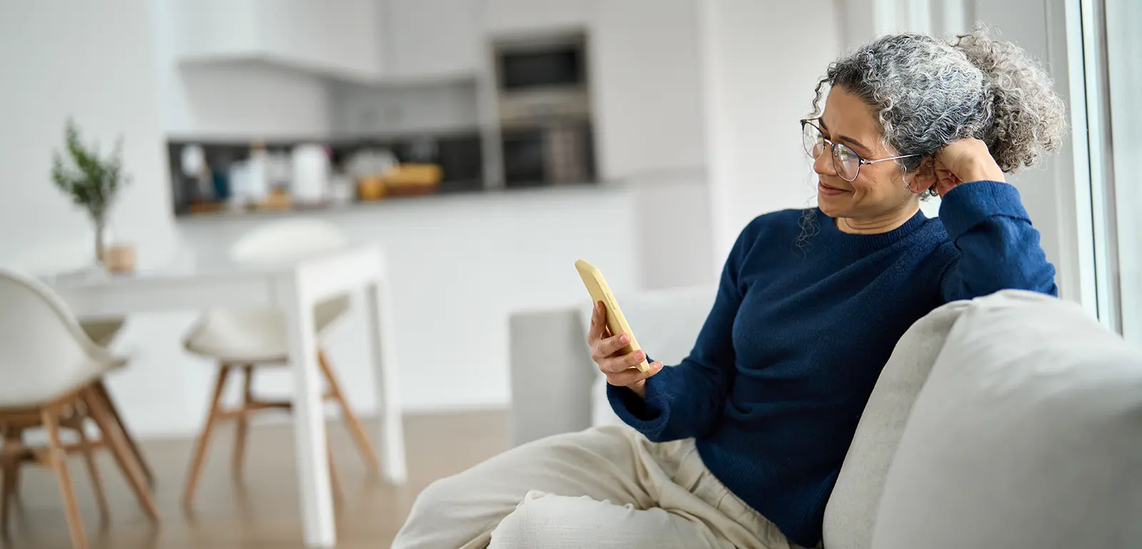 Woman looking at a damage restoration Local SEO campaign on phone